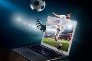 Laptop with football graphic showing football club management software for a winning season