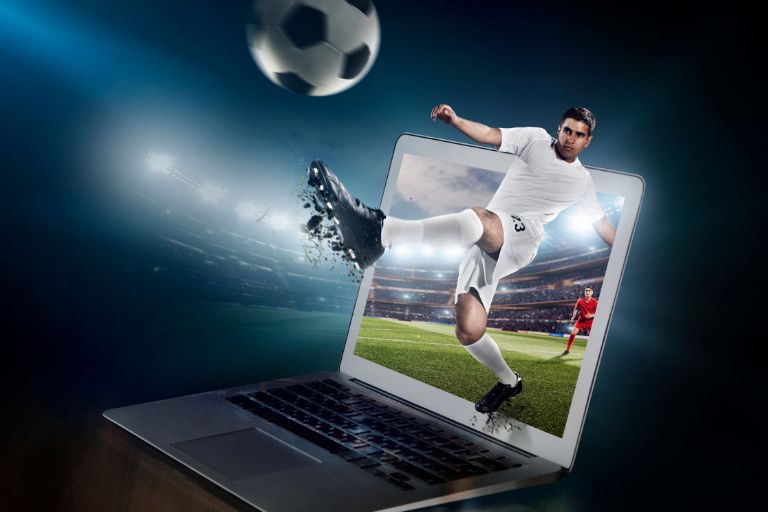 Laptop with football graphic showing football club management software for a winning season