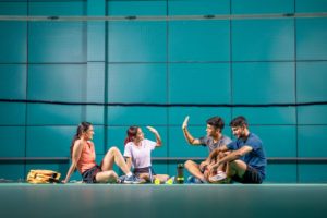 Happy badminton players resting, representing leisure centre software as an all-in-one facility solution